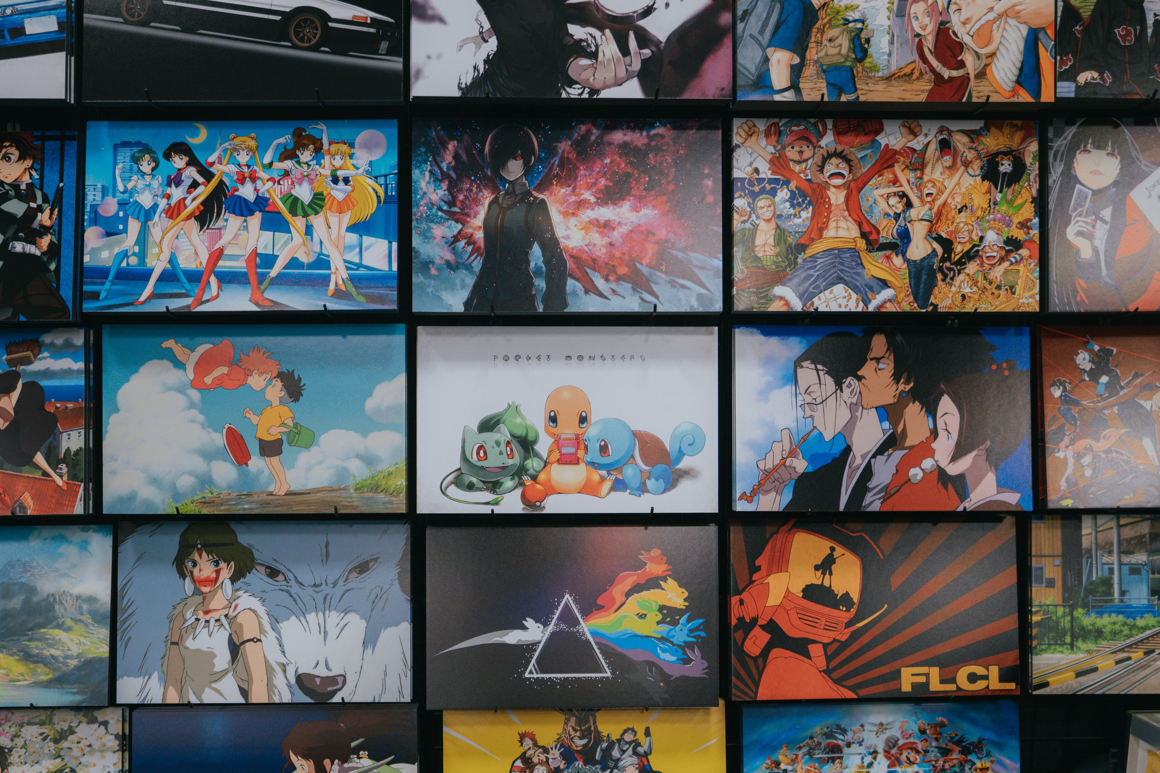 A wall filled with colorful anime and collector display art.