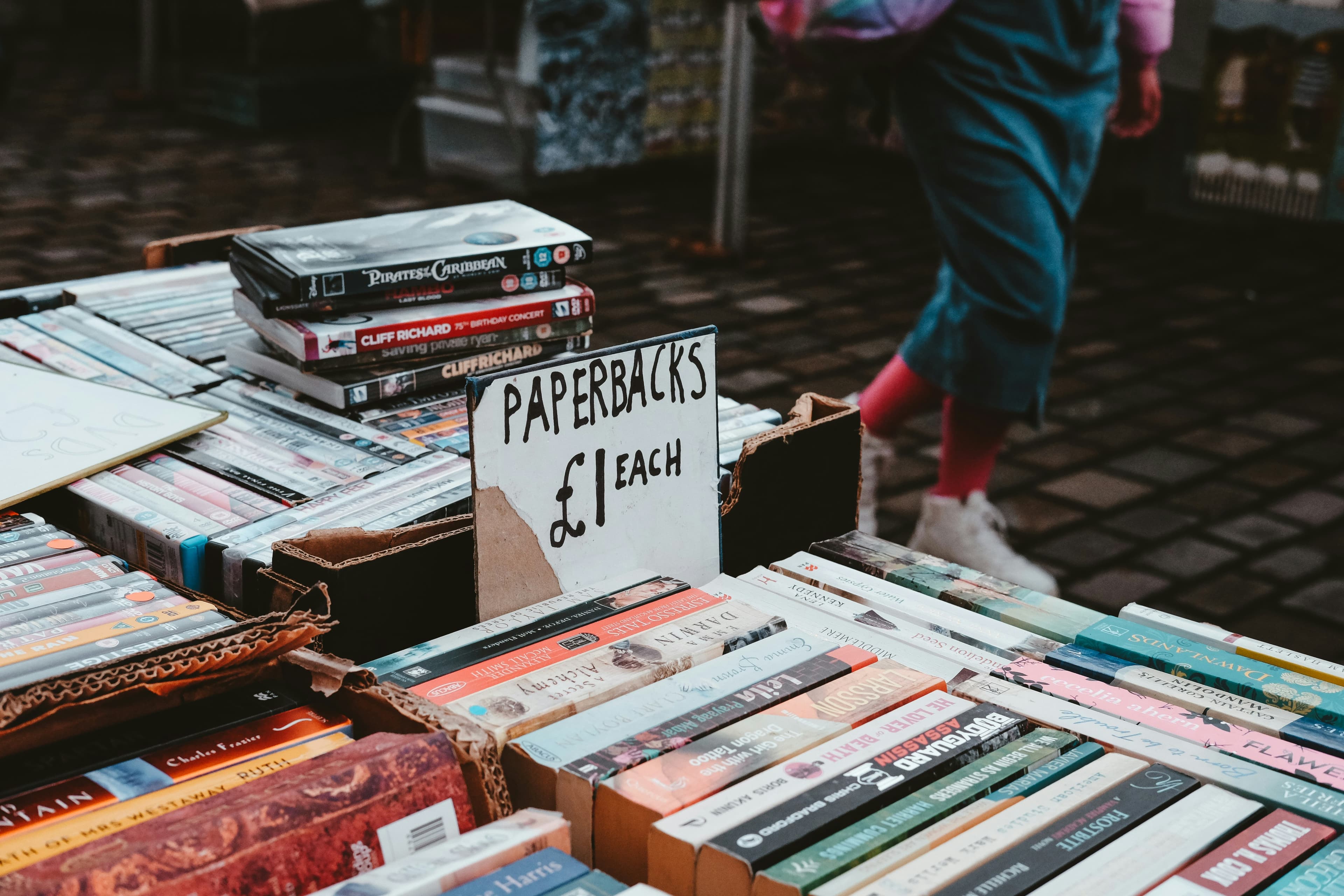 A market-style table with books and casual browsing energy.