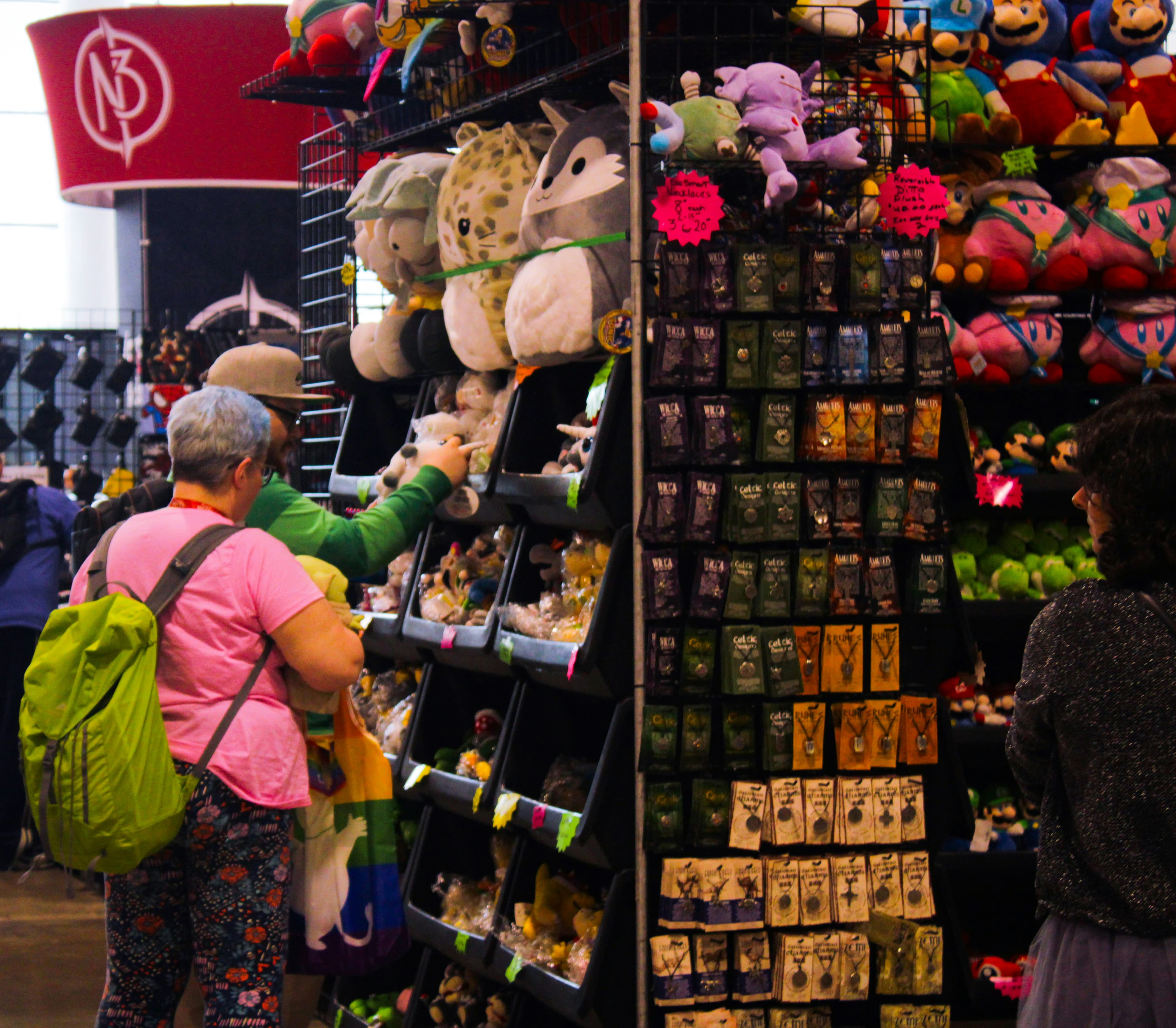 An event stall with collectables and people browsing.