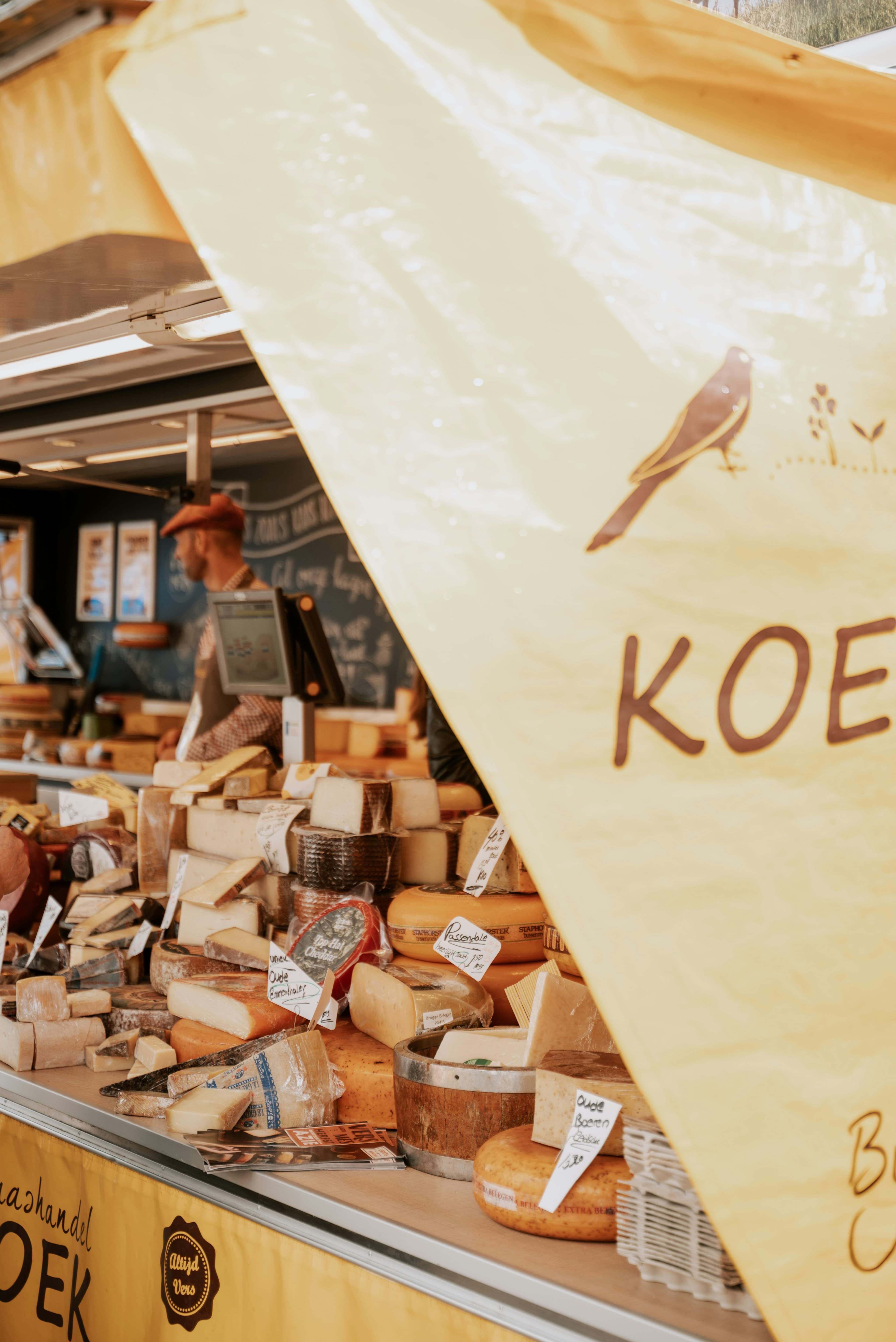 A vertical market scene with a stall and handmade product display.